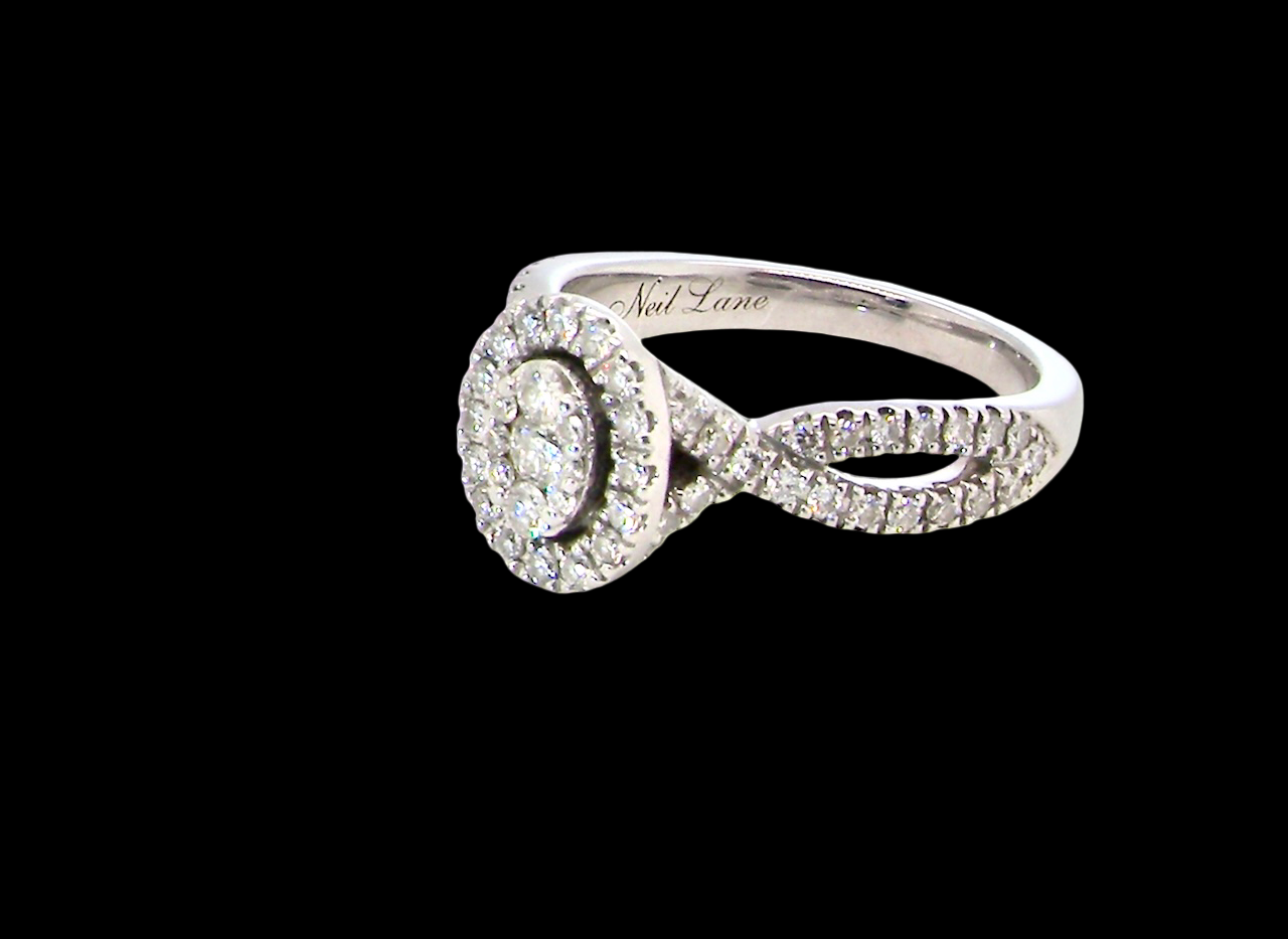 side A 14 carat white gold cluster ring. The centre cluster an oval setting with nine small white diamonds.
Around the outside a halo of sixteen smaller diamonds,