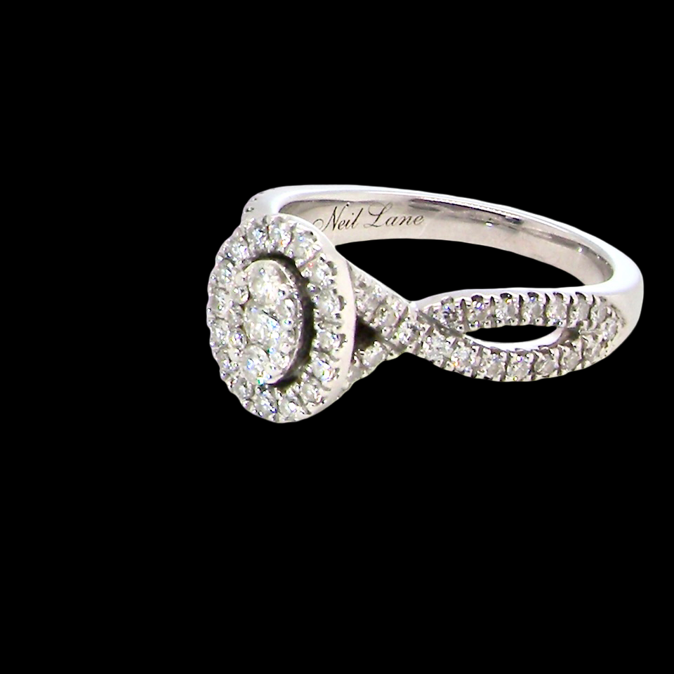 side A 14 carat white gold cluster ring. The centre cluster an oval setting with nine small white diamonds.
Around the outside a halo of sixteen smaller diamonds,