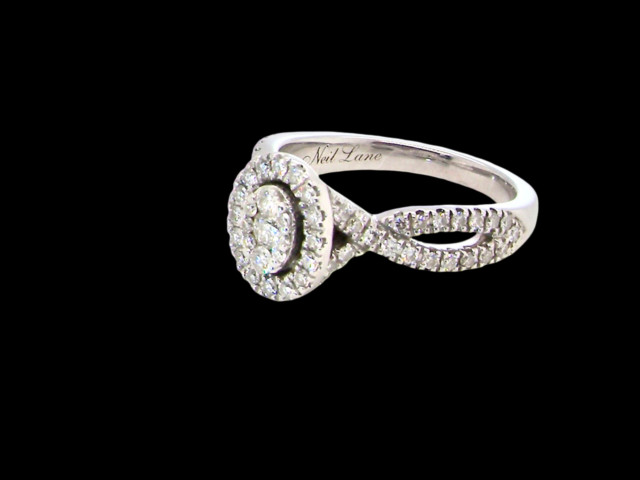 side A 14 carat white gold cluster ring. The centre cluster an oval setting with nine small white diamonds.
Around the outside a halo of sixteen smaller diamonds,