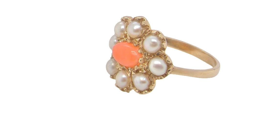 side. A 9 carat gold cluster ring. Centre stone an oval shaped coral stone 6x4mm.