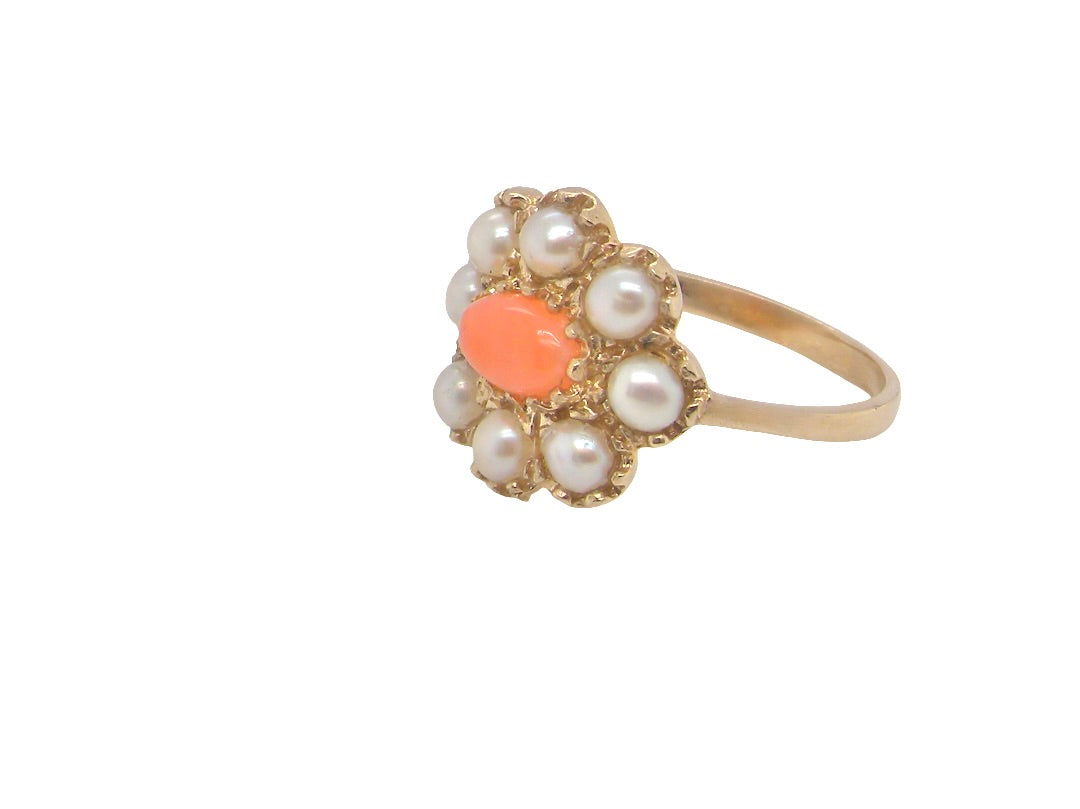 side. A 9 carat gold cluster ring. Centre stone an oval shaped coral stone 6x4mm.