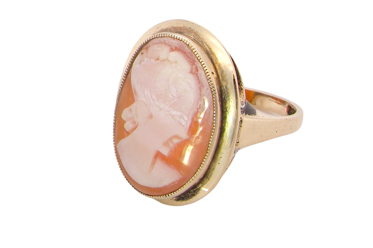 side A 9 carat gold dress ring that features a cameo shell. Carved with the head of a young woman. Measures 20x15mm.
