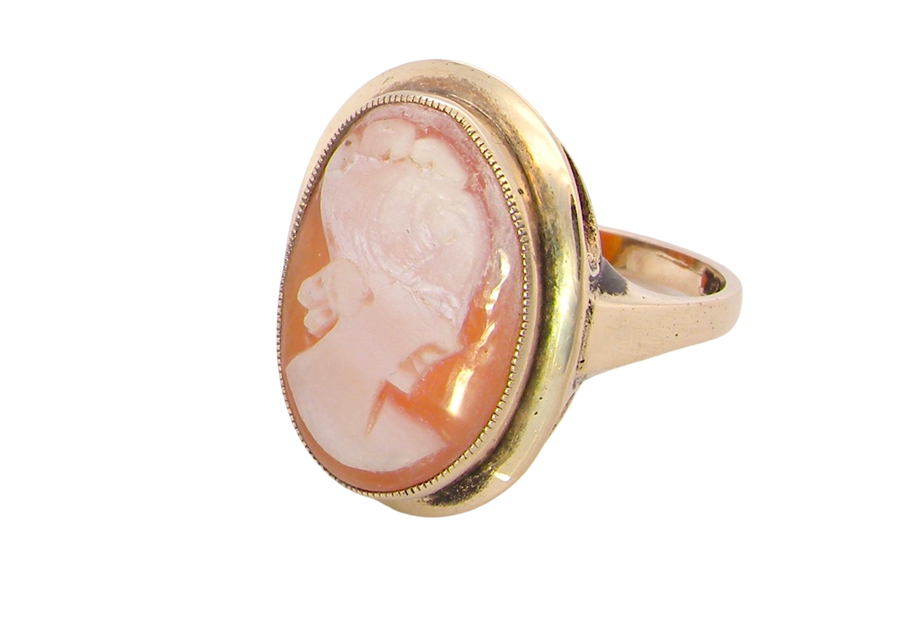 side A 9 carat gold dress ring that features a cameo shell. Carved with the head of a young woman. Measures 20x15mm.