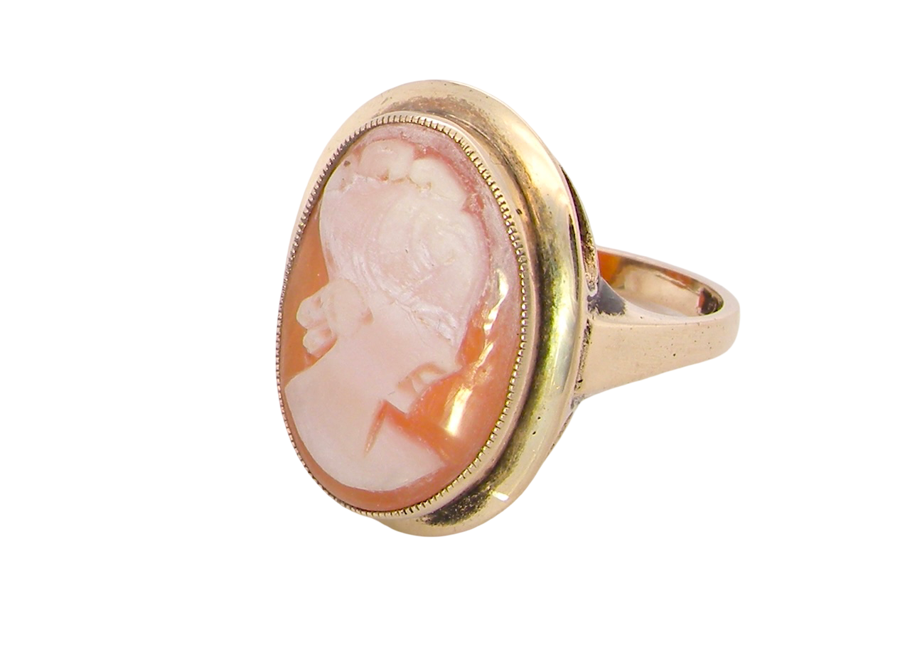 side A 9 carat gold dress ring that features a cameo shell. Carved with the head of a young woman. Measures 20x15mm.