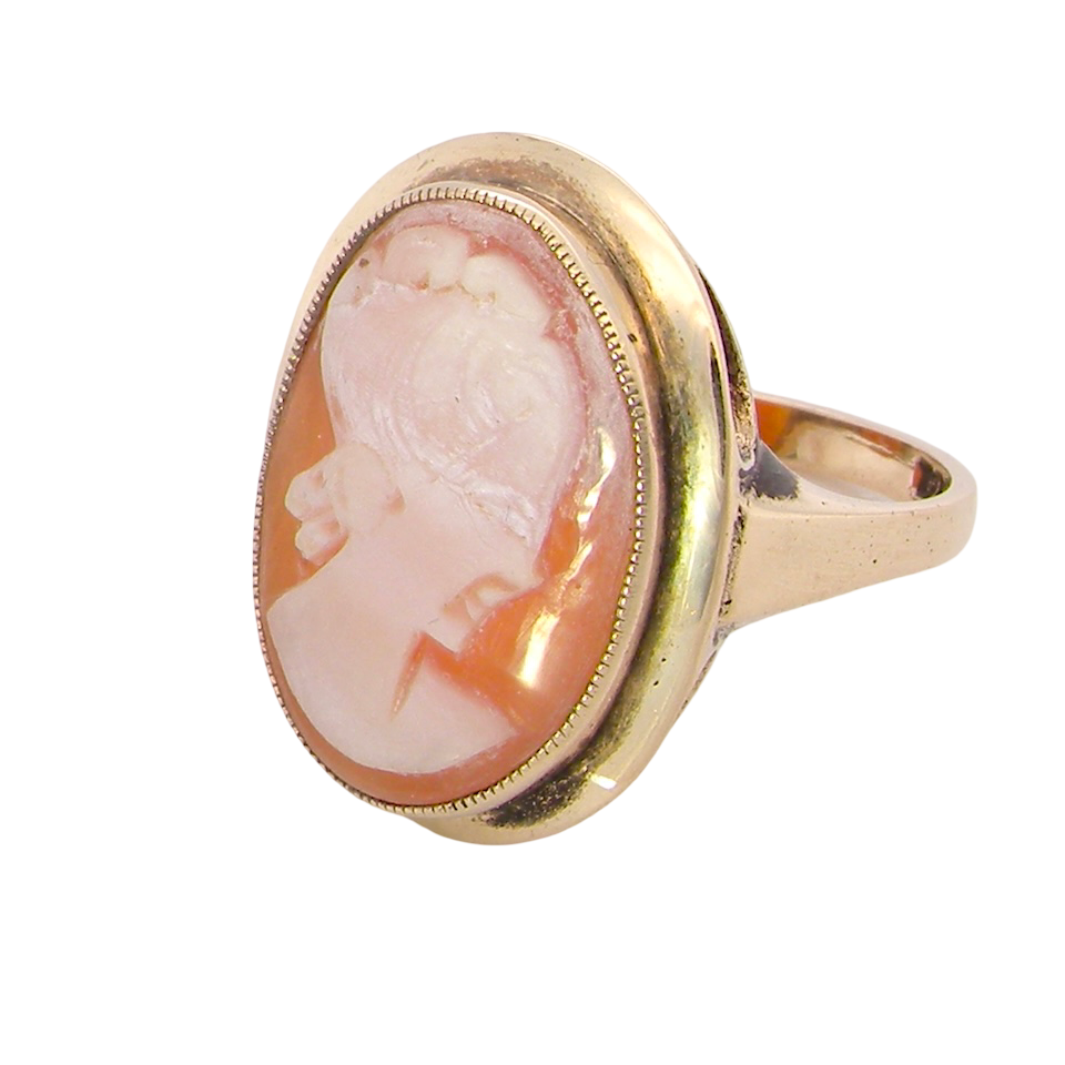 side A 9 carat gold dress ring that features a cameo shell. Carved with the head of a young woman. Measures 20x15mm.