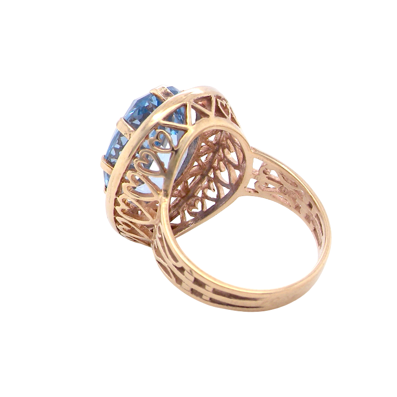 A 9 carat gold dress ring that features a large oval cut blue topaz gemstone. Measures 17x12mm. The head has a pierced outer border,