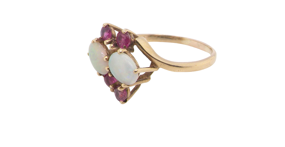 side A 9 carat gold dress ring that features two oval white opals, each 7x5mm, and four rubies each 3.4mm.