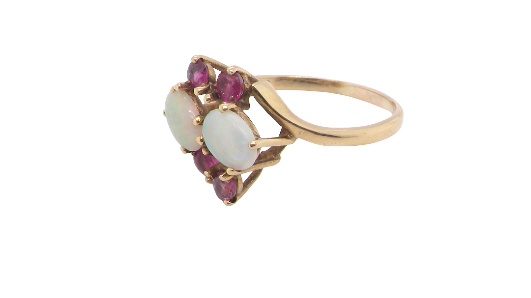 side A 9 carat gold dress ring that features two oval white opals, each 7x5mm, and four rubies each 3.4mm.