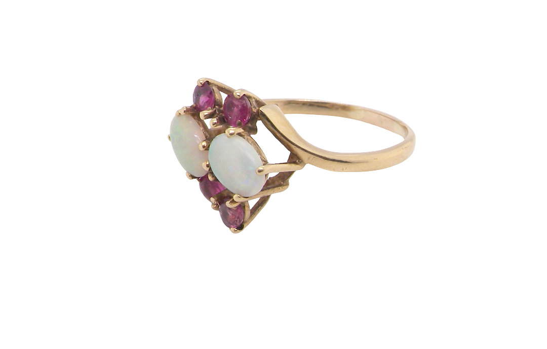 side A 9 carat gold dress ring that features two oval white opals, each 7x5mm, and four rubies each 3.4mm.