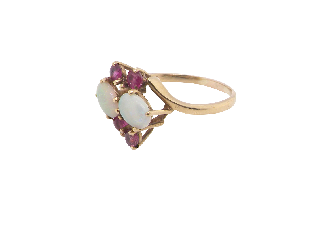 side A 9 carat gold dress ring that features two oval white opals, each 7x5mm, and four rubies each 3.4mm.
