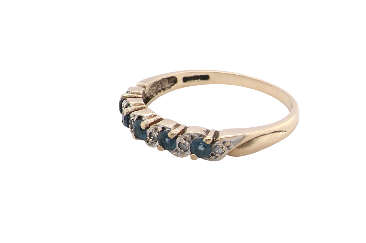 side A 9 carat gold half hoop eternity ring. Set with five blue topaz gem stones, each 2.8mm. 