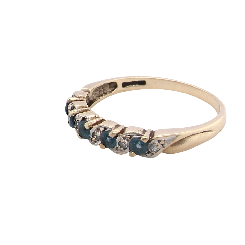 side A 9 carat gold half hoop eternity ring. Set with five blue topaz gem stones, each 2.8mm. 