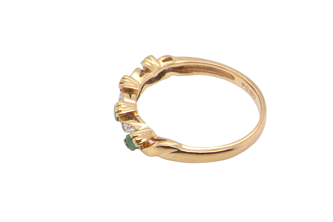 side A 9 carat gold half hoop eternity ring. Set with four 2.4mm emeralds.
Set in alternate sections, a 'lazy S' design,