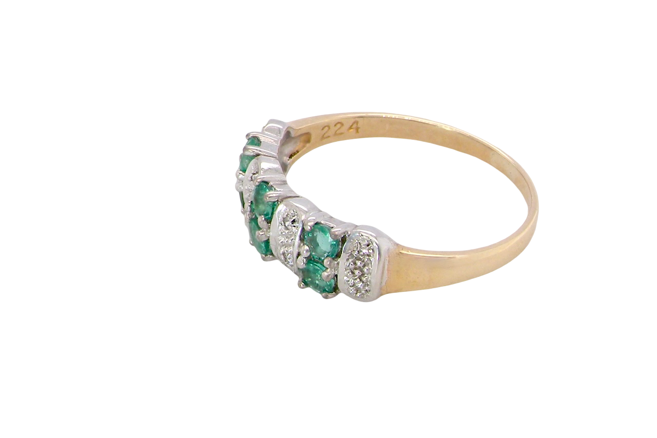 side A 9 carat gold half hoop ring. Set with six round emeralds 3mm each,(total 0.35 carats est) and interspaced with vertical white gold sections each set with 1mm diamonds.(0.05 carats est)