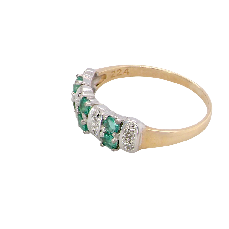 side A 9 carat gold half hoop ring. Set with six round emeralds 3mm each,(total 0.35 carats est) and interspaced with vertical white gold sections each set with 1mm diamonds.(0.05 carats est)