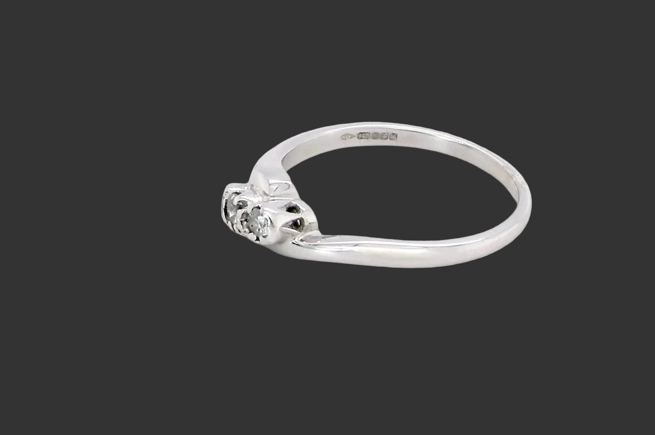 side A 9 carat white gold cross over style trilogy ring. Three x 0.10mm diamonds, to an estimated at 0.30 carats.