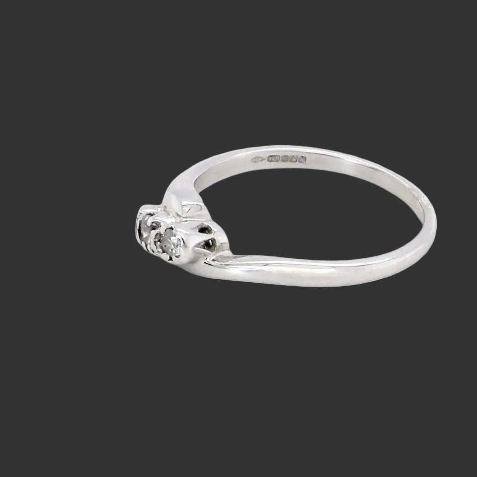 side A 9 carat white gold cross over style trilogy ring. Three x 0.10mm diamonds, to an estimated at 0.30 carats.