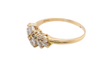Gold ring with diamond-like stones on a white background