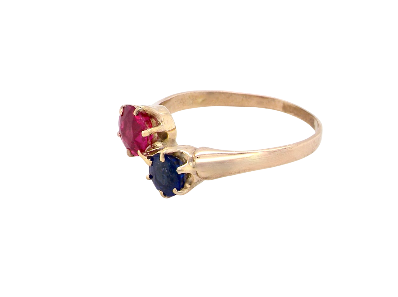 Gold ring with red and blue gemstones on a white background