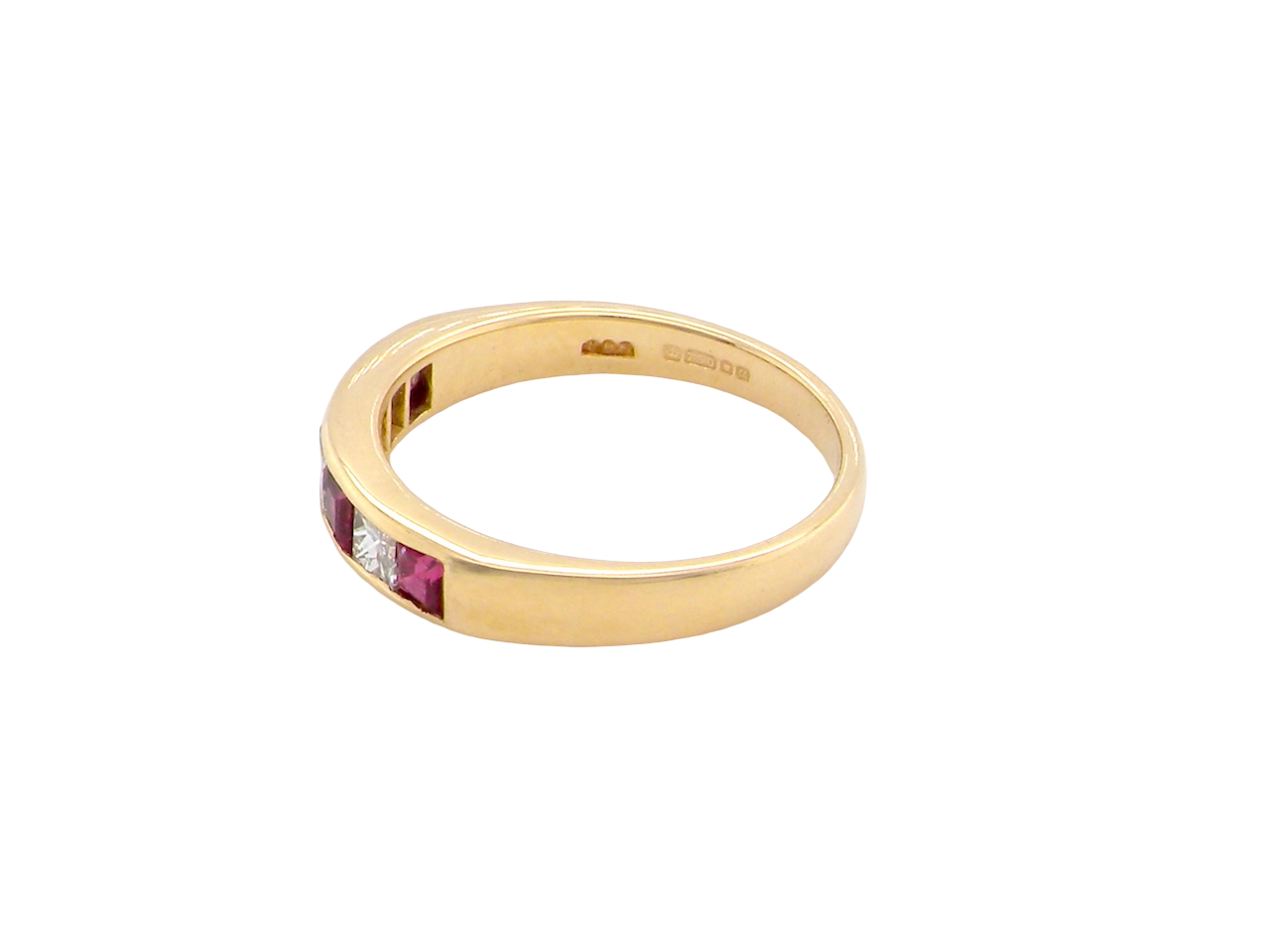 An 18-carat gold half-hoop eternity ring set with alternating rubies and diamonds.