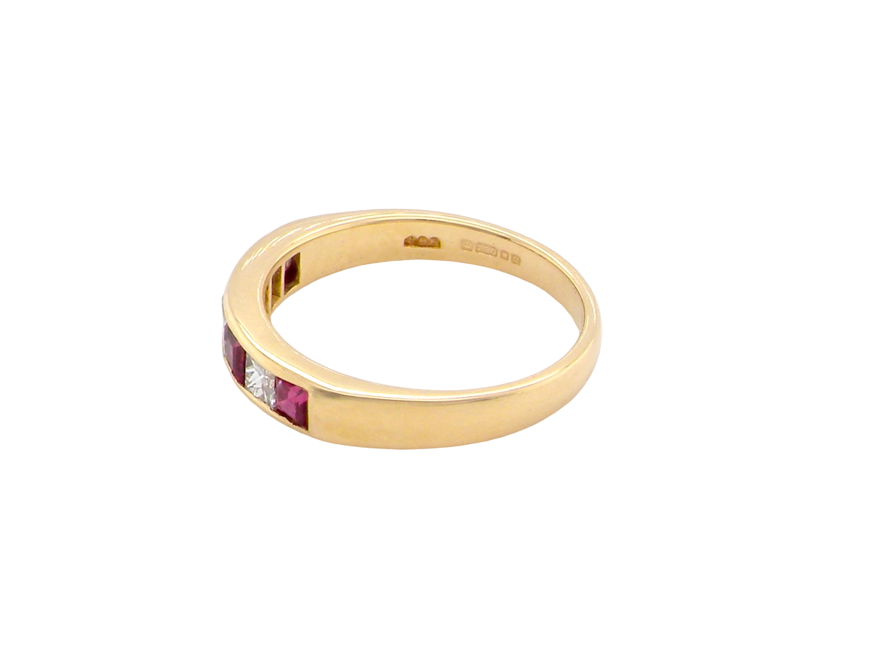 An 18-carat gold half-hoop eternity ring set with alternating rubies and diamonds.