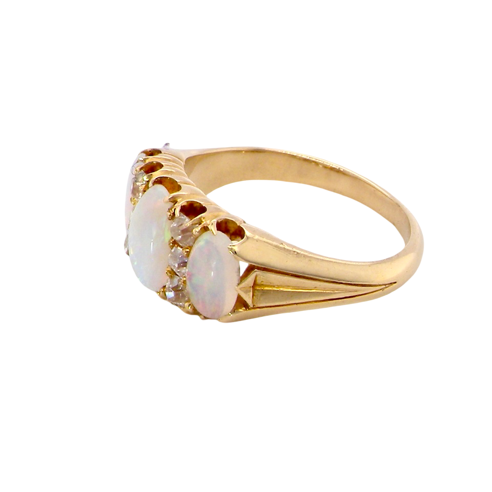 side A beautiful Victorian dress ring, set with three finely matched oval opals,