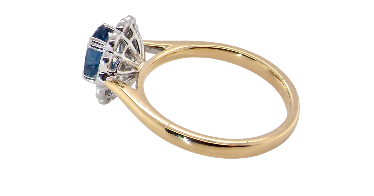side A beautiful cluster ring featuring an oval-cut mid to dark blue sapphire measuring 7 × 5 mm (approximately ¾ carat).