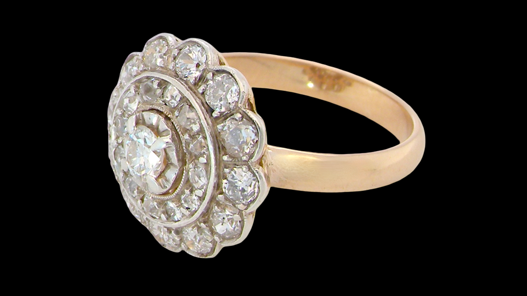 side A beautiful vintage diamond cluster ring. Know as a target cluster, the diamonds are old brilliant cut. Centre diamond 3.8mm (0.20 carats) . 