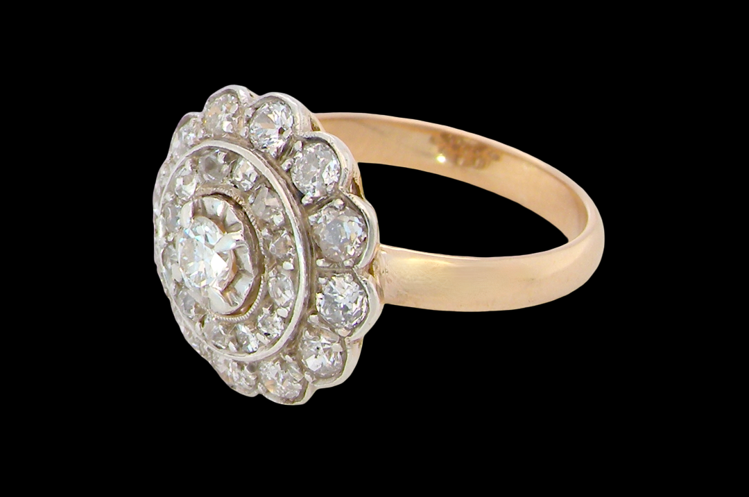 side A beautiful vintage diamond cluster ring. Know as a target cluster, the diamonds are old brilliant cut. Centre diamond 3.8mm (0.20 carats) . 