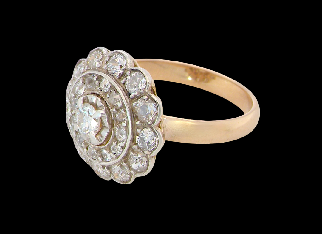 side A beautiful vintage diamond cluster ring. Know as a target cluster, the diamonds are old brilliant cut. Centre diamond 3.8mm (0.20 carats) . 