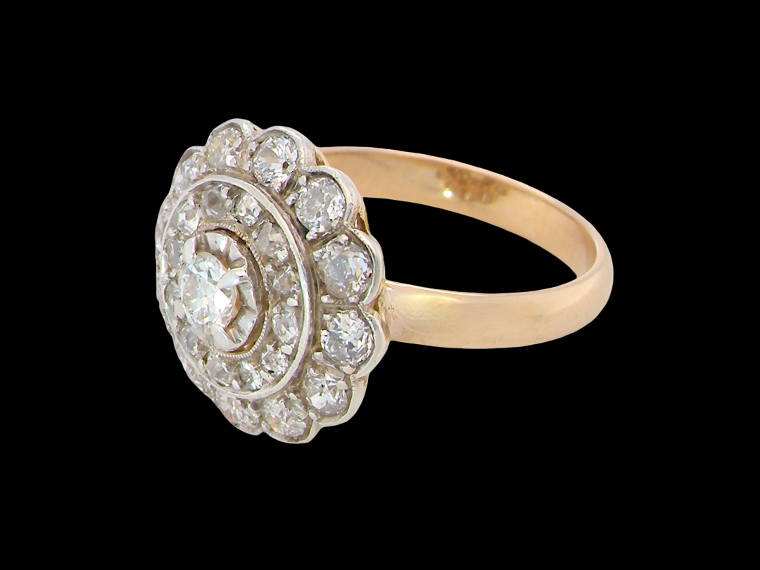 side A beautiful vintage diamond cluster ring. Know as a target cluster, the diamonds are old brilliant cut. Centre diamond 3.8mm (0.20 carats) . 