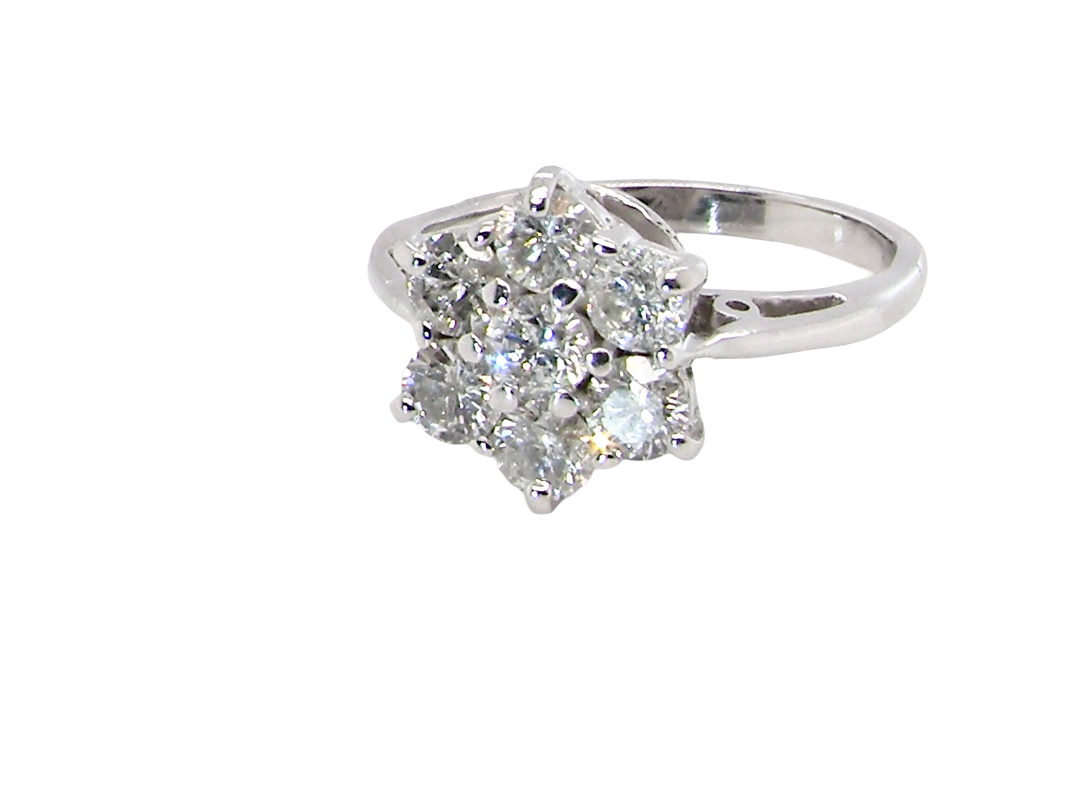 side A beautiful vintage diamond cluster ring, elegantly set with seven brilliant-cut white diamonds in a timeless floral cluster design.