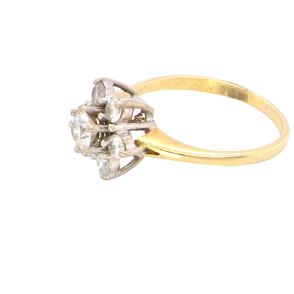 side A beautifully crafted vintage diamond cluster ring, dating to the 1960s, featuring a classic floral-inspired design that remains timeless and elegant.