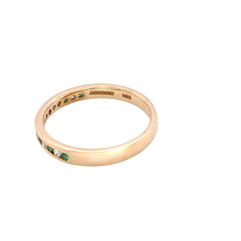 side A brand new half hoop eternity ring. Set with eight 1.3mm emeralds (total 0.12 carats) and interspaced with brilliant cut white diamonds, each 1.3mm (0.10 carats)