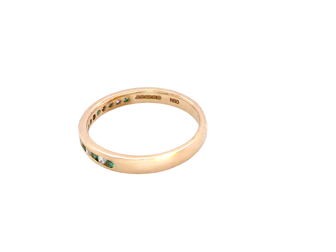 side A brand new half hoop eternity ring. Set with eight 1.3mm emeralds (total 0.12 carats) and interspaced with brilliant cut white diamonds, each 1.3mm (0.10 carats)