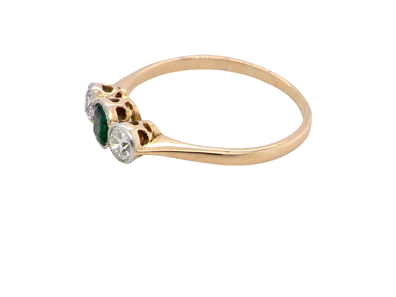 side A charming ring dating from the early to mid-20th century, beautifully crafted and full of period character.
The centrepiece is a vivid bright-green, cushion-shaped emerald