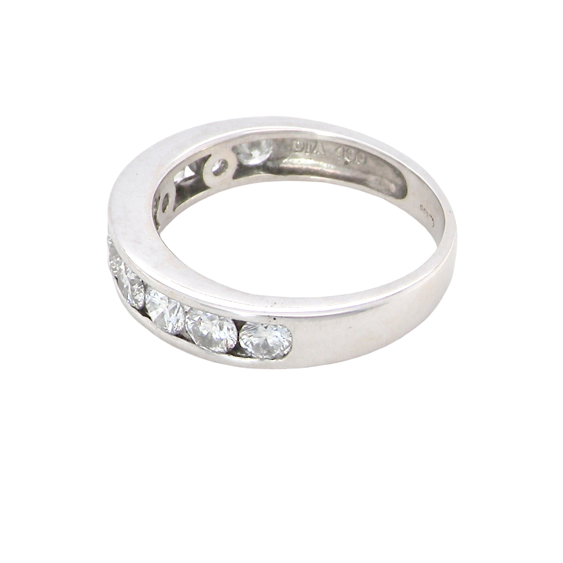 A silver band ring featuring a row of clear oval-cut gemstones along the front, photographed on a plain white background.