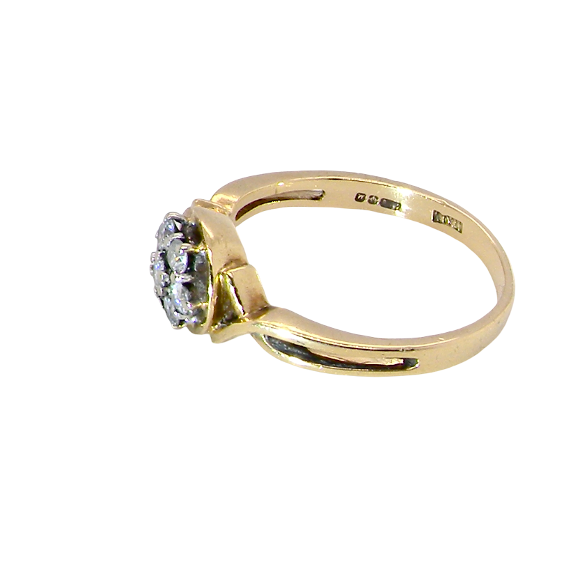 side A classic 1980s cluster ring. Seven brilliant cut white diamonds , each 2.5mm (est 0.40 carats). Colour i-j, clarity Si. Claw set in white gold.