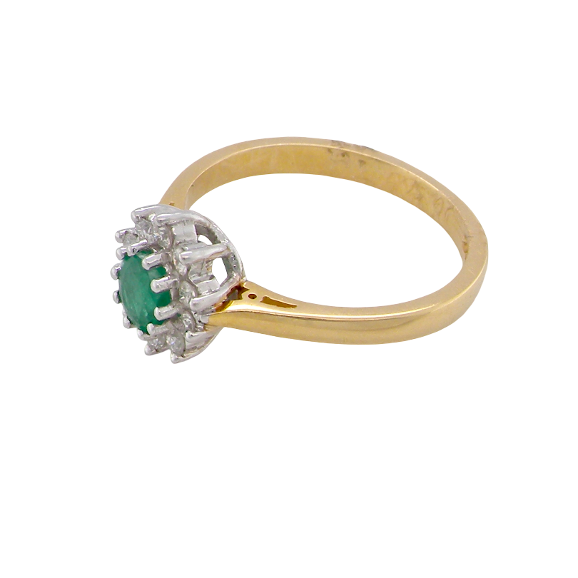 side A classic cluster ring. Features to the centre a round emerald, comlimented by an outerv halo of brilliant cut white diamonds