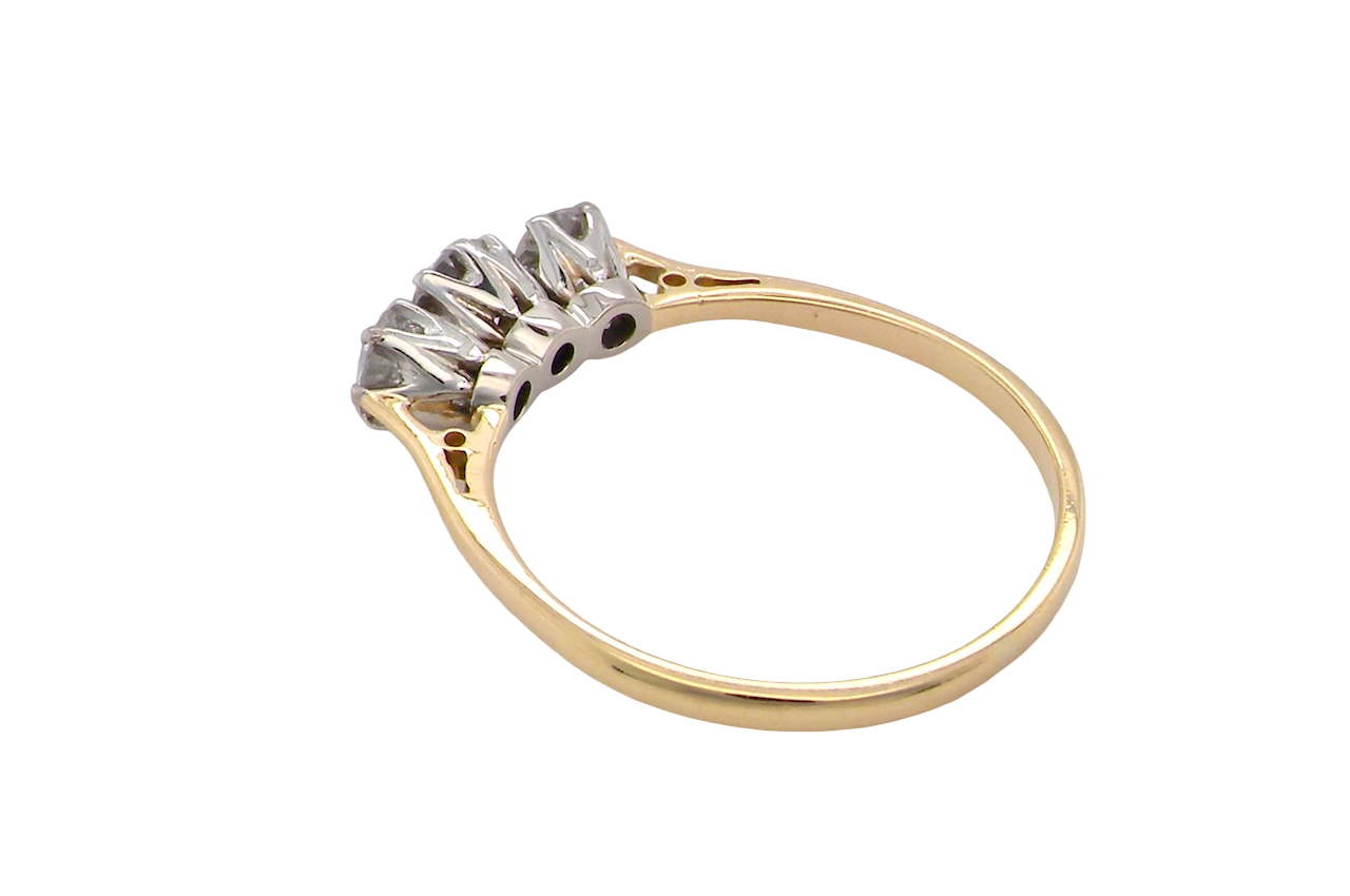 Gold ring with a diamond on a white background