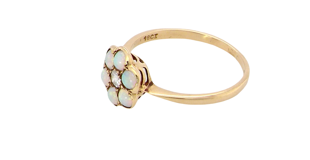 side A daisy cluster dress ring. Set with a small diamond centre stone, diameter 3mm (0.10 carats)