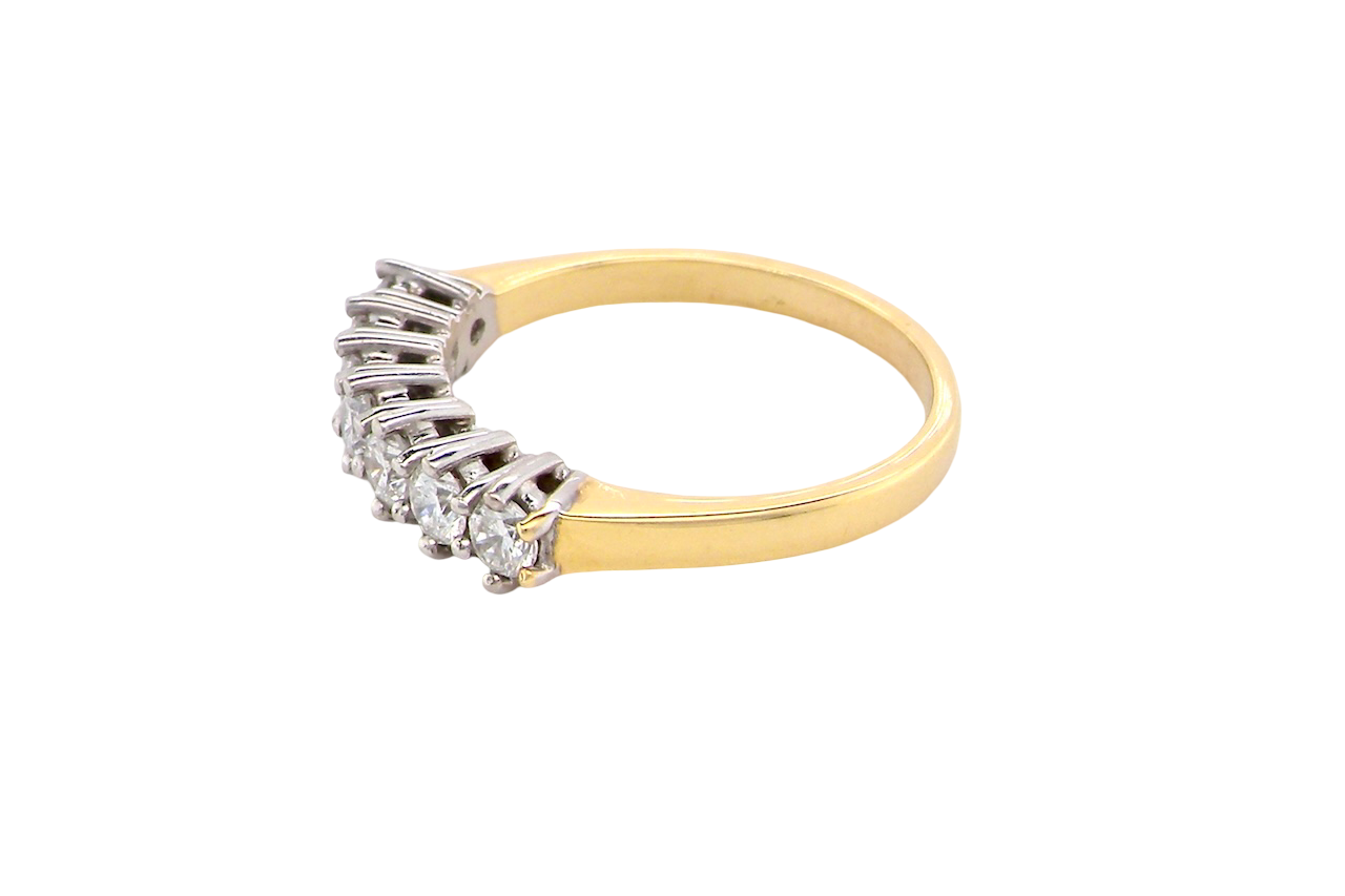 side A fine 18 carat gold half hoop eternity ring, beautifully set with an array of seven brilliant-cut white diamonds.