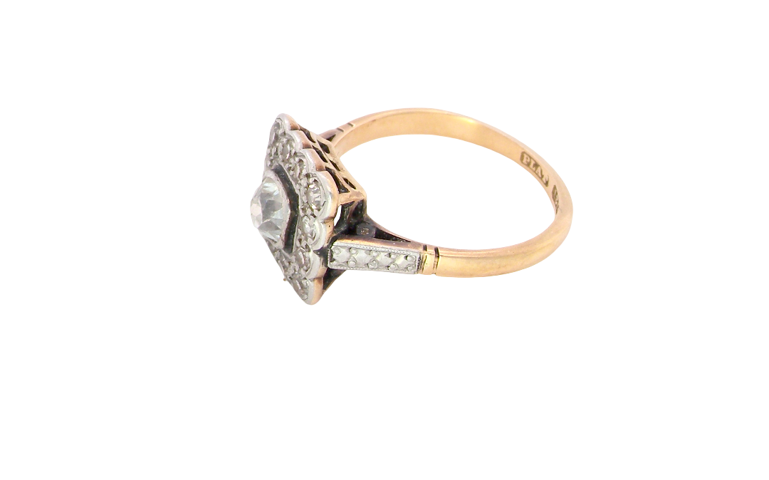 side A fine antique ring from the early part of the 20th century (probably 1915-1925)
A square head that measures 11x11mm is set with old brilliant cut white diamonds. The principal stone measures just over half a carat (5.2mm) colour i-l, clarity Si, rim setting, platinum.