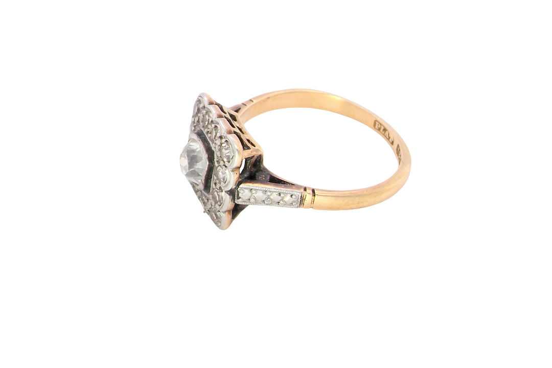 side A fine antique ring from the early part of the 20th century (probably 1915-1925)
A square head that measures 11x11mm is set with old brilliant cut white diamonds. The principal stone measures just over half a carat (5.2mm) colour i-l, clarity Si, rim setting, platinum.