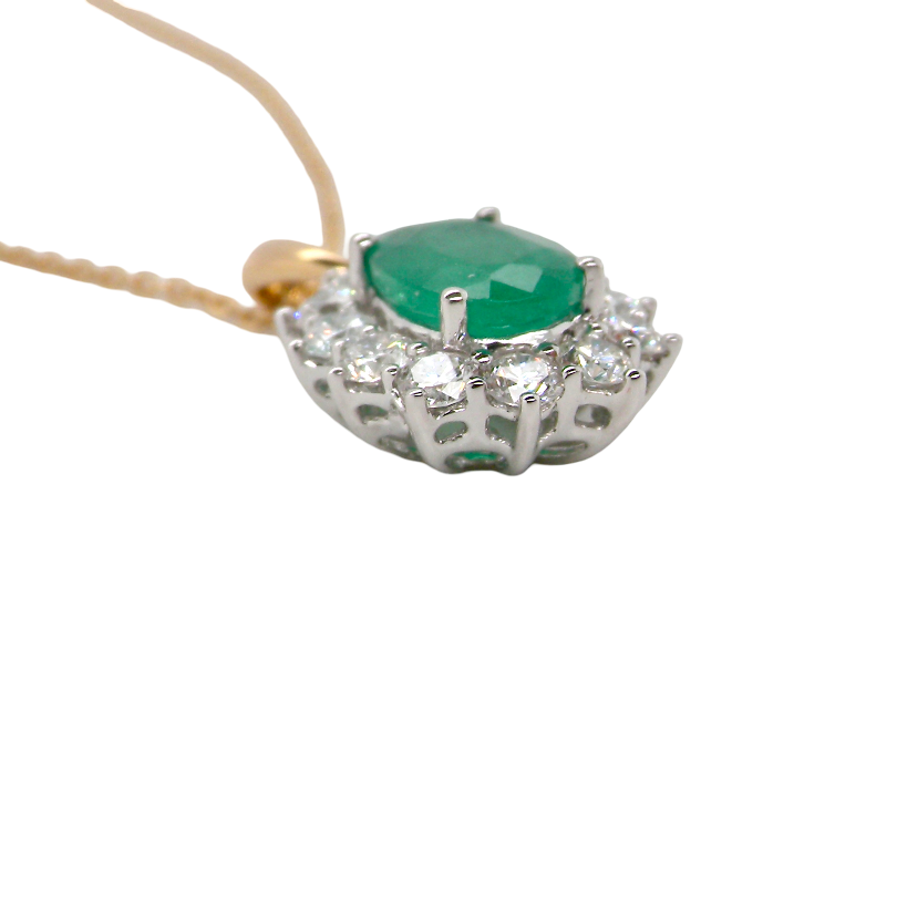 side A fine cluster pendant. Features at the centre an oval cut emerald, measures 7.5x5mm (est one carat). Dark green hue, natural inclusions.