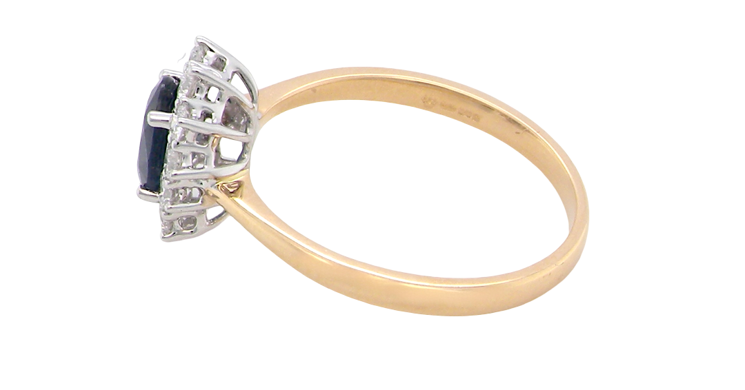 side A fine cluster ring that features a black blue oval cut sapphire that measures 7x5mm (est 0.75 carats)