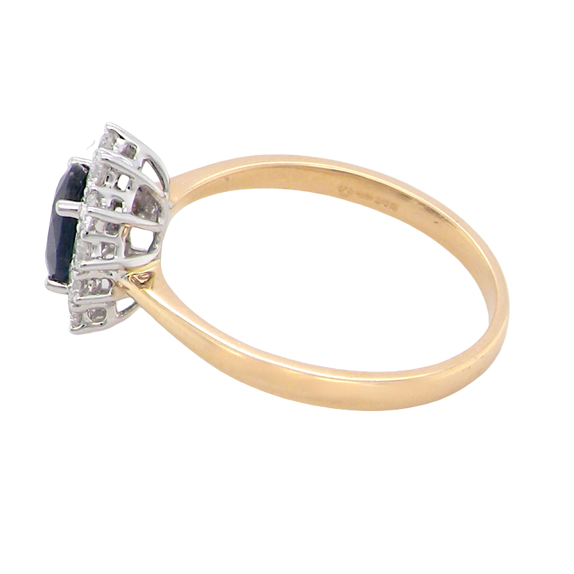 side A fine cluster ring that features a black blue oval cut sapphire that measures 7x5mm (est 0.75 carats)