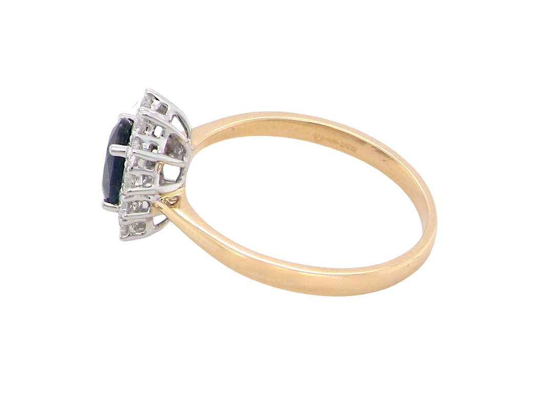 side A fine cluster ring that features a black blue oval cut sapphire that measures 7x5mm (est 0.75 carats)