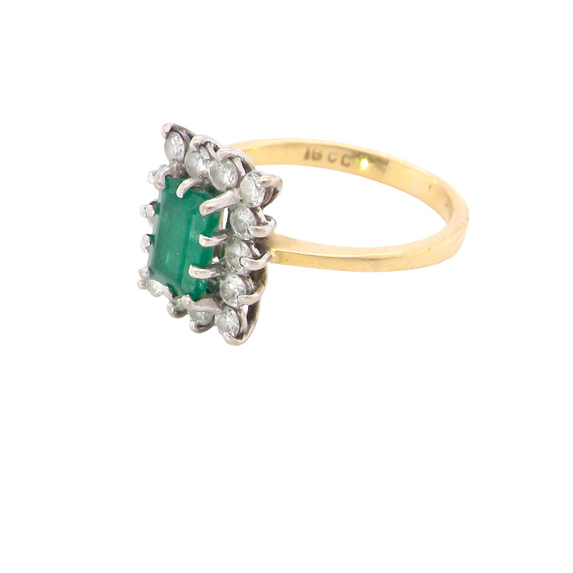 side A fine cluster ring that features a rectangular mid to dark green emerald, measures 8x6mm (est 0.50 carats) 