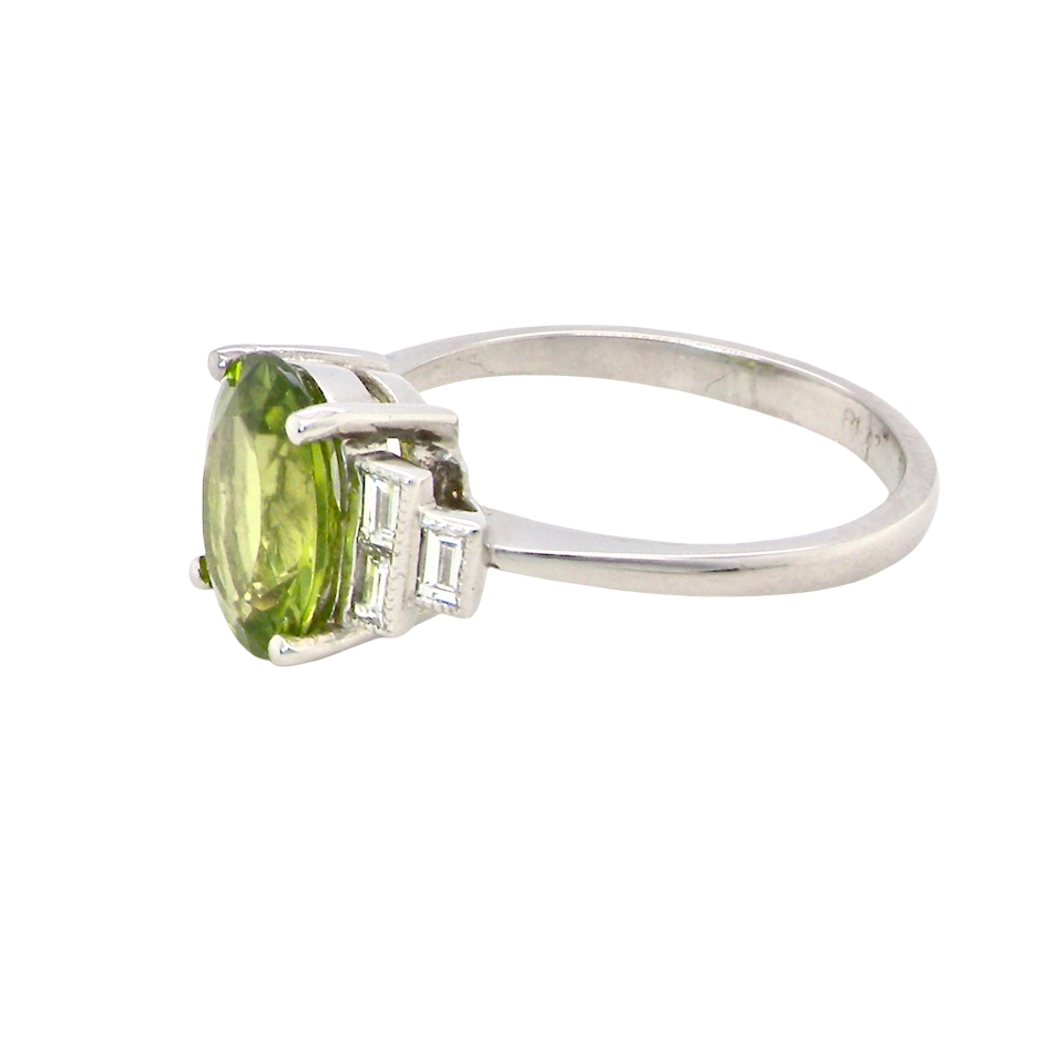 side A fine gem set ring featuring a vibrant lime-green oval faceted peridot,